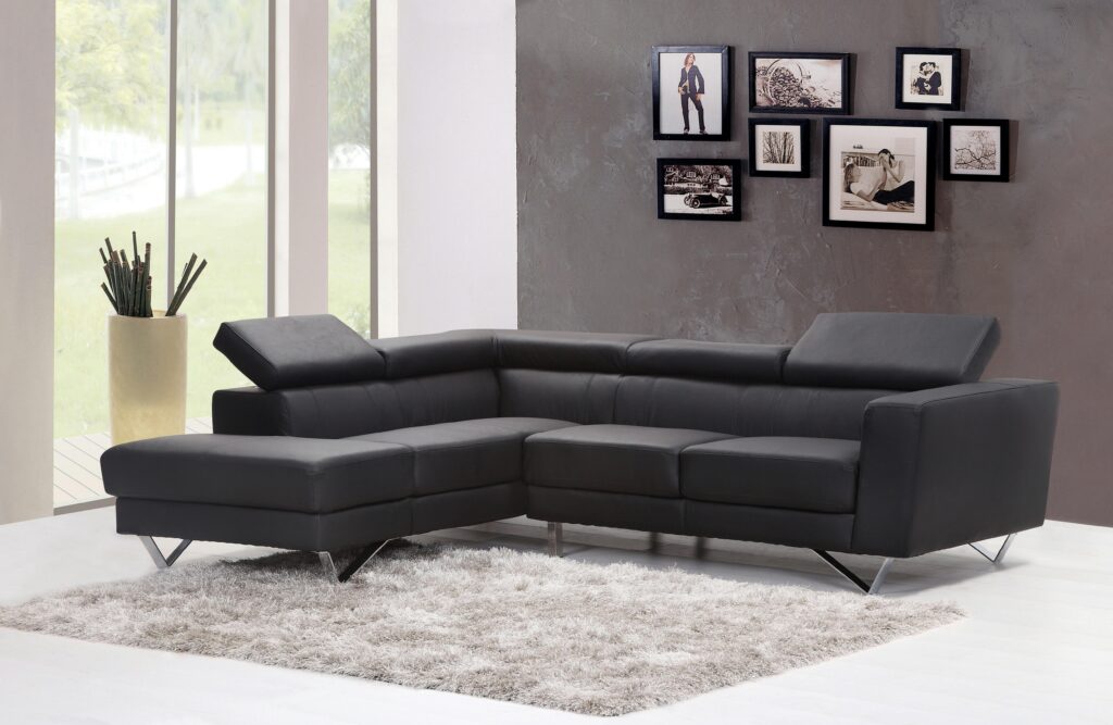 pexels photo 276583 276583 Contemporary living room featuring a sleek black sectional sofa and chic wall art.