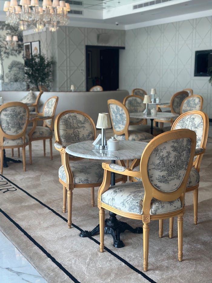 services-04 Chic French-style cafe with elegant chairs and marble tables, perfect for a relaxing experience.